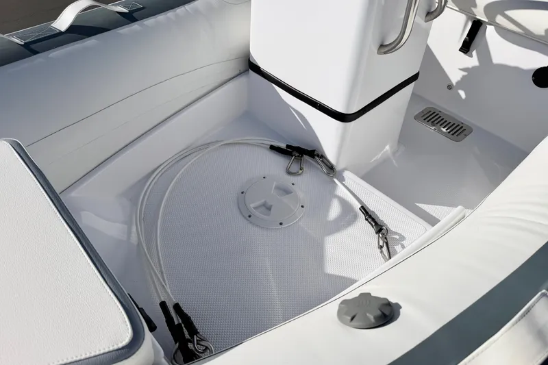 Slide: The Image of 2021 Novurania Deluxe 335 boat interior with white seating and safety ropes. - 24