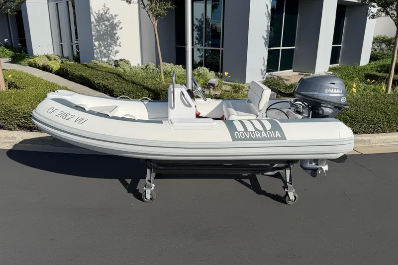 Slide: The Image of 2021 Novurania Deluxe 335 inflatable boat with Yamaha motor on display outdoors. - 9