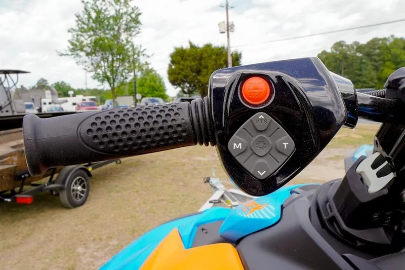 Slide: The Image of Close-up of 2026 Sea-Doo Spark Trixx handlebar controls with vibrant colors. - 14