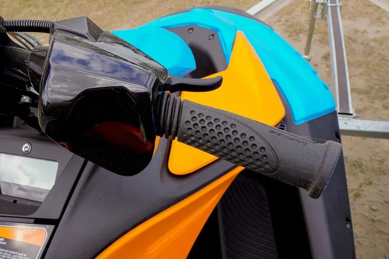 Slide: The Image of Close-up of 2026 Sea-Doo Spark Trixx handlebar with vibrant orange and blue design. - 15