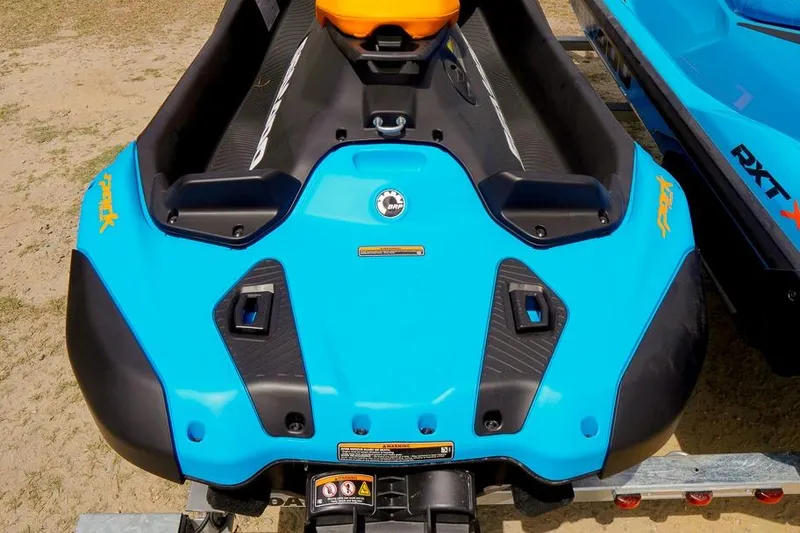 Slide: The Image of 2026 Sea-Doo Spark Trixx jet ski, vibrant blue design, rear view on sandy terrain. - 5