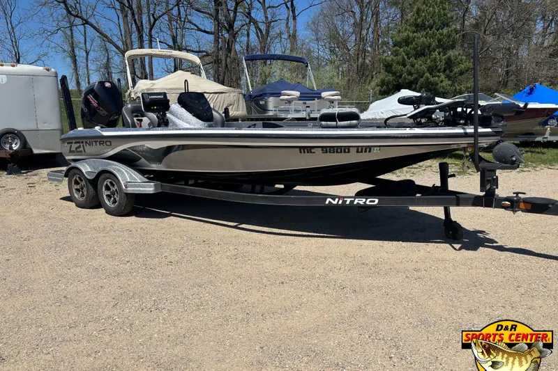 The Image of 2019 Nitro Z21 boat on trailer in outdoor setting, featuring sleek design and dual axles. - 0