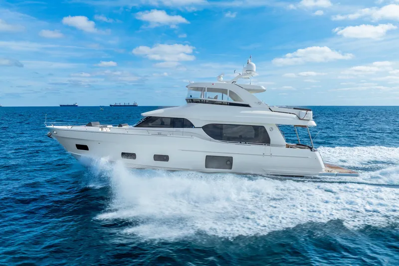 Slide: The Image of 2021 Ocean Alexander 70E Motoryacht cruising on open sea under clear skies. - 12