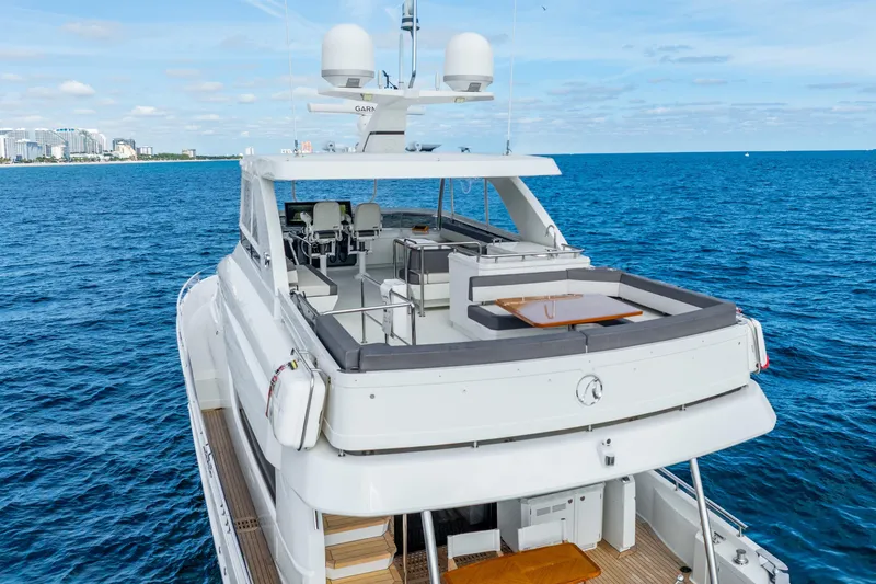 Slide: The Image of 2021 Ocean Alexander 70E Motoryacht cruising on blue ocean near city skyline. - 15