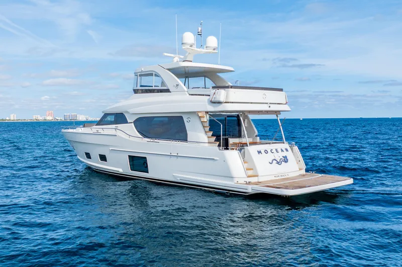 Slide: The Image of 2021 Ocean Alexander 70E Motoryacht cruising on open blue sea. - 2
