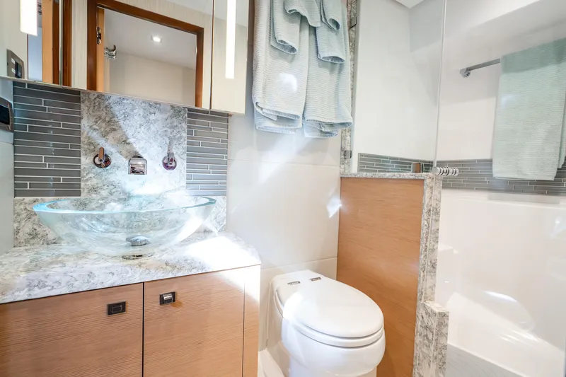Slide: The Image of Luxurious bathroom in 2021 Ocean Alexander 70E Motoryacht with glass sink and modern fixtures. - 49