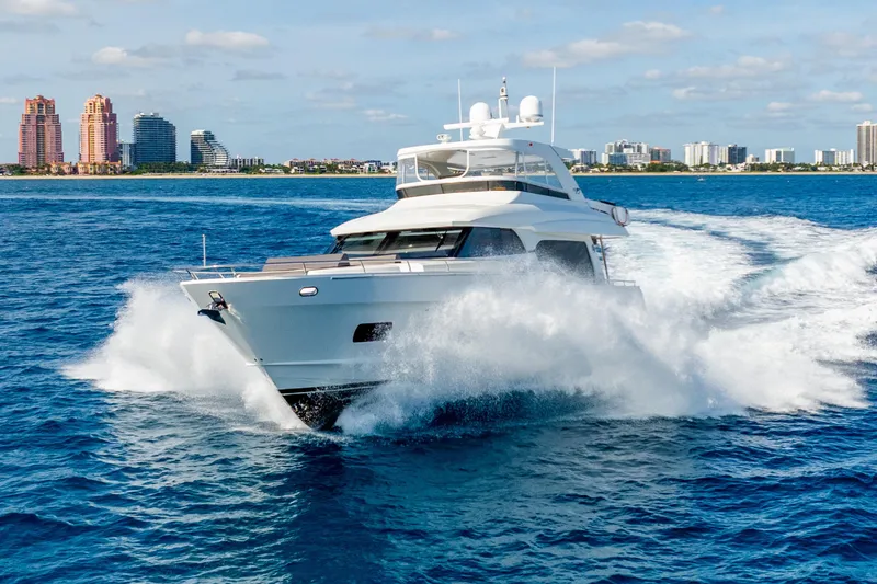Slide: The Image of 2021 Ocean Alexander 70E Motoryacht cruising on blue ocean near city skyline. - 5