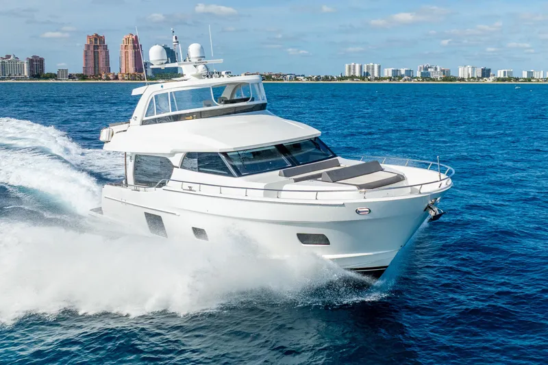 Slide: The Image of 2021 Ocean Alexander 70E Motoryacht cruising on blue ocean near city skyline. - 6