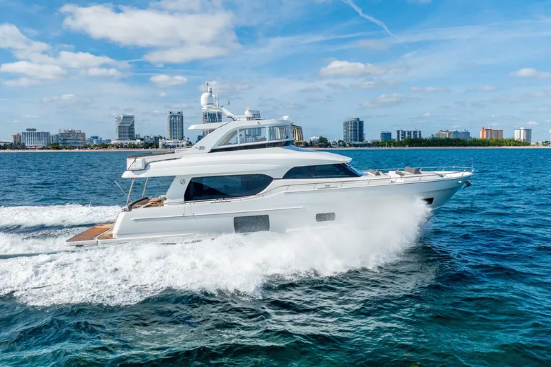 Slide: The Image of 2021 Ocean Alexander 70E Motoryacht cruising on blue ocean near city skyline. - 7