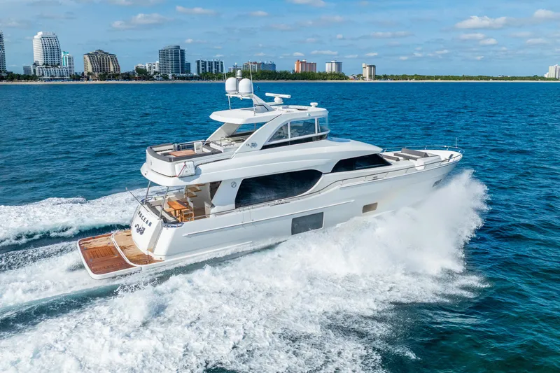Slide: The Image of 2021 Ocean Alexander 70E Motoryacht cruising on blue ocean near city skyline. - 9