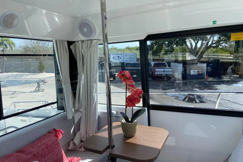 Slide: The Image of Interior of 2026 Jeanneau NC Sport 795 Series 2 with table and decorative plant. - 29