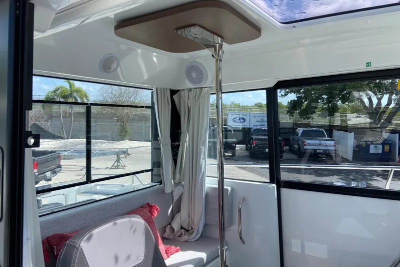 Slide: The Image of Interior of 2026 Jeanneau NC Sport 795 Series 2 boat with seating and windows. - 30