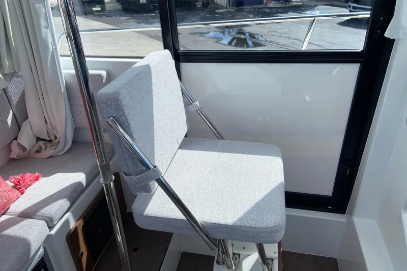 Slide: The Image of Interior of 2026 Jeanneau NC Sport 795 Series 2, featuring a modern cushioned seat. - 31