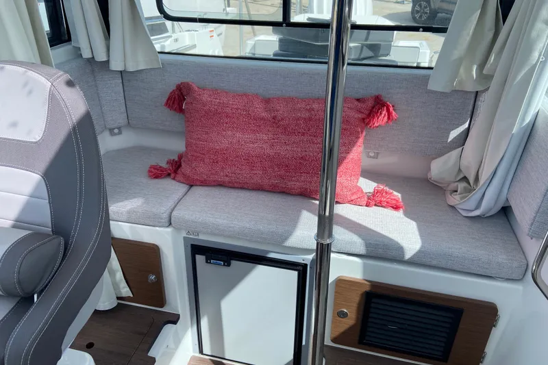 Slide: The Image of Interior of 2026 Jeanneau NC Sport 795 Series 2 with gray seating and red cushion. - 33