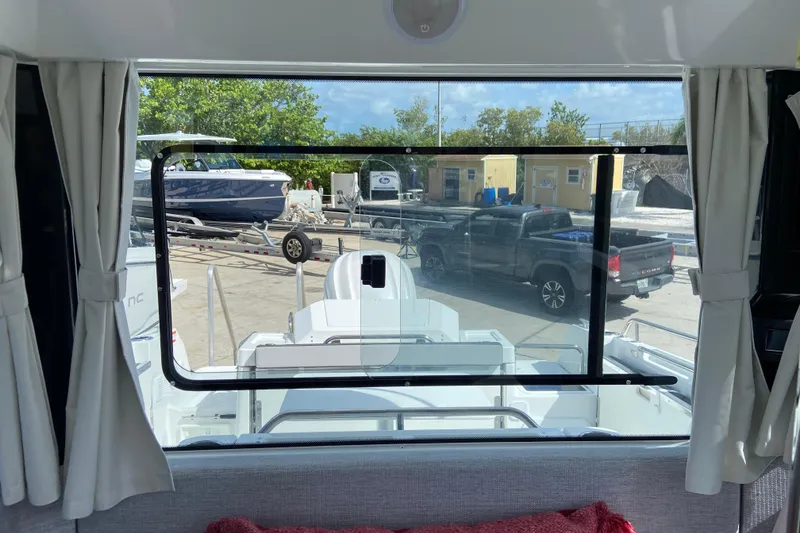 Slide: The Image of Interior view from Jeanneau NC Sport 795 Series 2, showcasing docked boats and vehicles outside. - 37