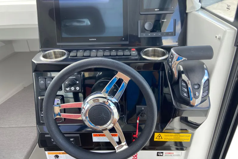 Slide: The Image of Steering console of 2026 Jeanneau NC Sport 795 Series 2 with modern controls and displays. - 39