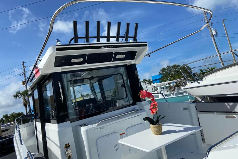 Slide: The Image of 2026 Jeanneau NC Sport 795 Series 2 boat with outdoor seating and floral decor. - 4