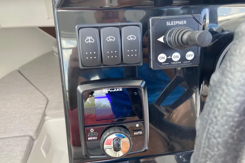 Slide: The Image of Control panel of 2026 Jeanneau NC Sport 795 Series 2 boat with switches and thruster controls. - 41