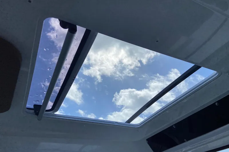 Slide: The Image of Open sunroof view from Jeanneau NC Sport 795 Series 2, 2026 model, showcasing blue sky and clouds. - 45