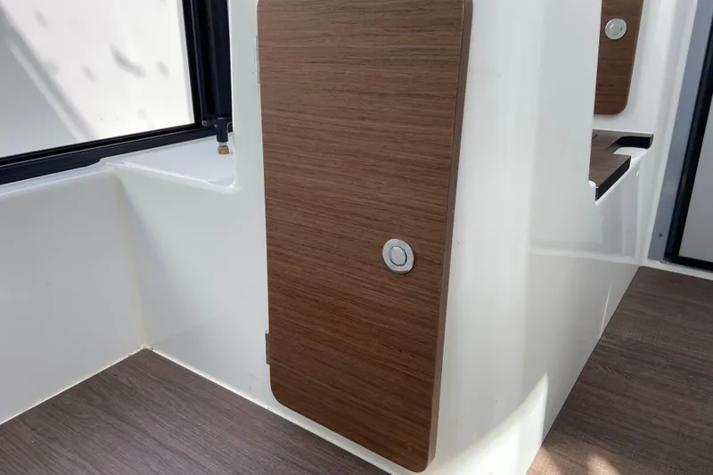 Slide: The Image of Interior view of 2026 Jeanneau NC Sport 795 Series 2, featuring wooden paneling and modern design. - 48