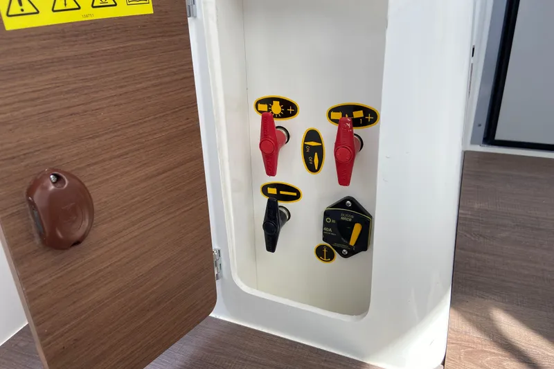 Slide: The Image of Control panel of 2026 Jeanneau NC Sport 795 Series 2 boat with switches and labels. - 49