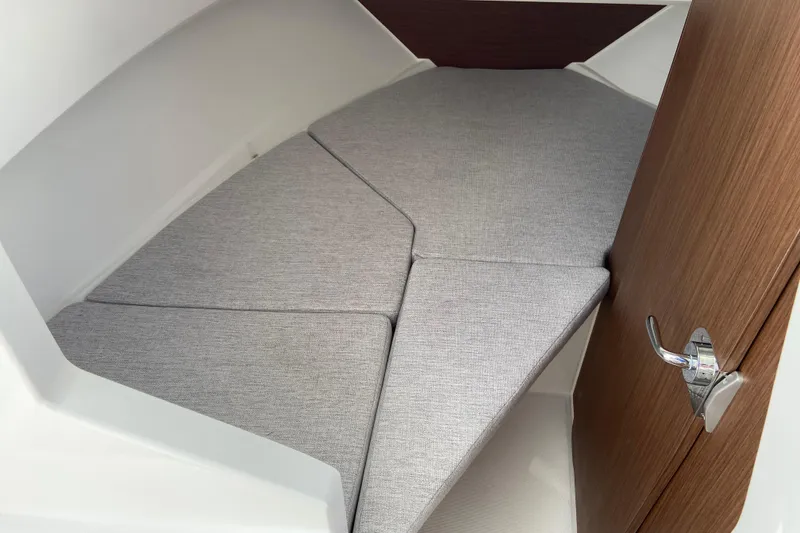 Slide: The Image of 2026 Jeanneau NC Sport 795 Series 2 cabin interior with gray cushions and wooden door. - 50