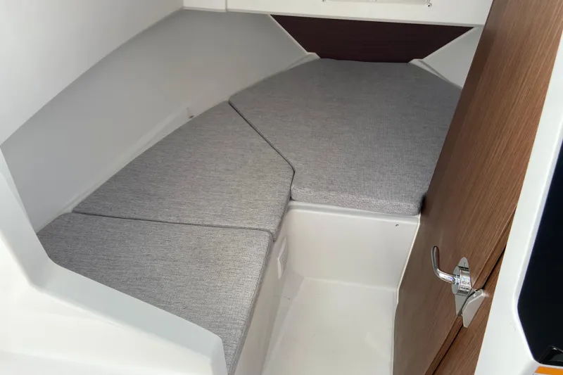 Slide: The Image of 2026 Jeanneau NC Sport 795 Series 2 cabin interior with grey cushions and wooden door. - 51