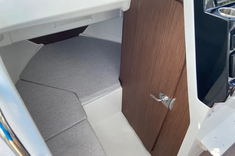 Slide: The Image of 2026 Jeanneau NC Sport 795 Series 2 cabin interior with wooden door and cushioned seating. - 54