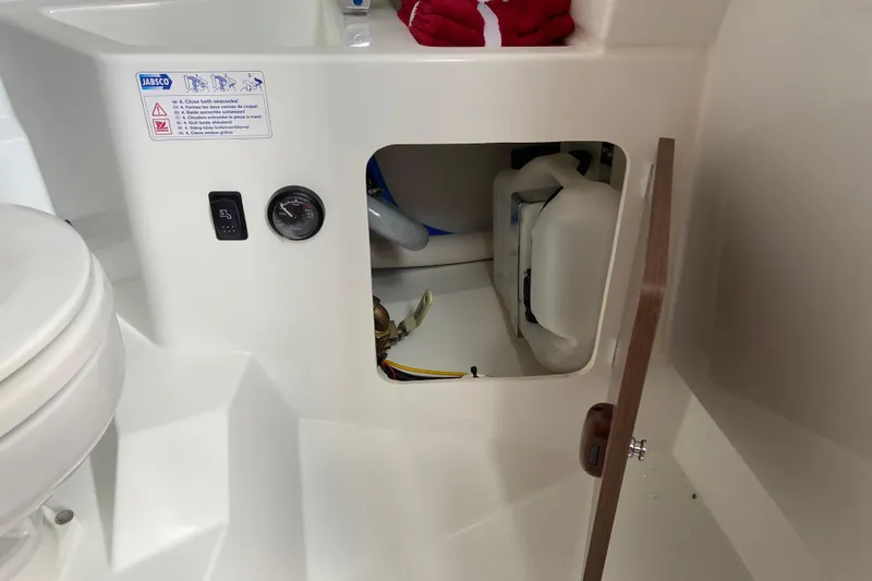 Slide: The Image of Interior view of Jeanneau NC Sport 795 Series 2, showcasing storage compartment and controls. - 56