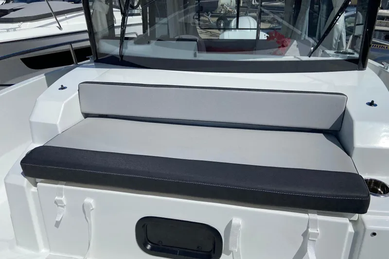 Slide: The Image of 2026 Jeanneau NC Sport 795 Series 2 boat seating area with cushioned bench. - 66