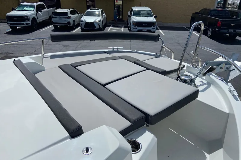 Slide: The Image of 2026 Jeanneau NC Sport 795 Series 2 boat deck with cushioned seating in a parking lot. - 68