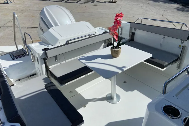 Slide: The Image of 2026 Jeanneau NC Sport 795 Series 2 boat interior with seating and table. - 7