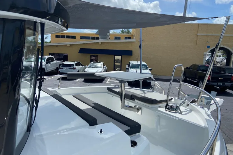 Slide: The Image of 2026 Jeanneau NC Sport 795 Series 2 boat with seating and canopy in a parking lot. - 71