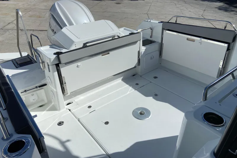 Slide: The Image of 2026 Jeanneau NC Sport 795 Series 2 boat deck with outboard motor and seating area. - 9