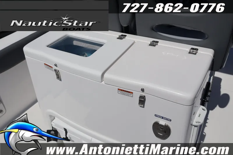 Slide: The Image of NauticStar 292 Legacy 2026 boat cooler with fresh water compartment, contact info displayed. - 11