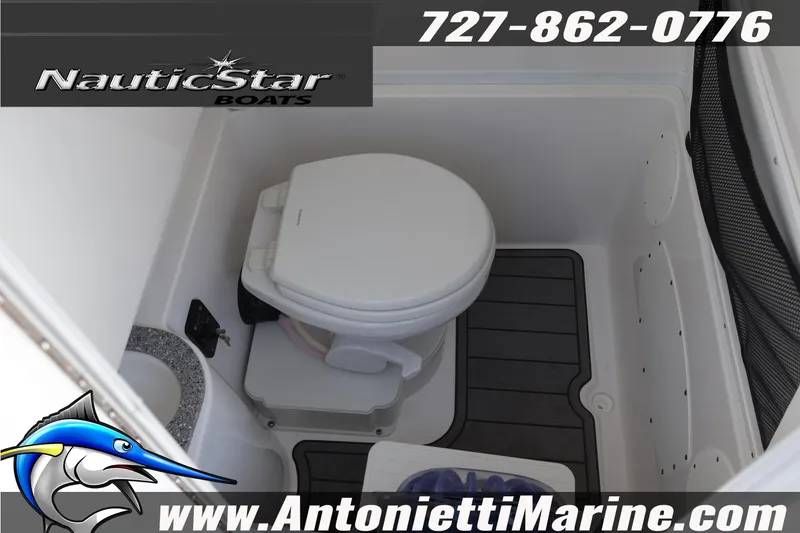 Slide: The Image of Interior of 2026 NauticStar 292 Legacy boat featuring a compact marine toilet. - 33