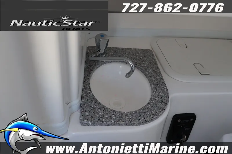 Slide: The Image of 2026 NauticStar 292 Legacy boat sink with granite countertop, featuring Antonietti Marine branding. - 34