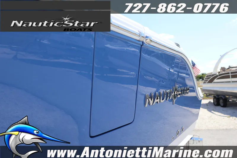 Slide: The Image of 2026 NauticStar 292 Legacy boat in blue, displayed at Antonietti Marine. - 7