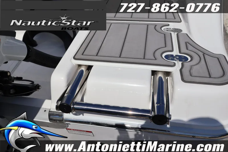 Slide: The Image of 2026 NauticStar 292 Legacy boat with swim platform and ladder, featuring marine branding. - 8