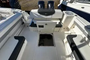 Slide: The Image of 2022 Robalo R317 Dual Console boat interior with seating and storage compartments. - 12