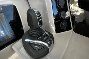 Slide: The Image of 2022 Robalo R317 Dual Console joystick control system on boat dashboard. - 13