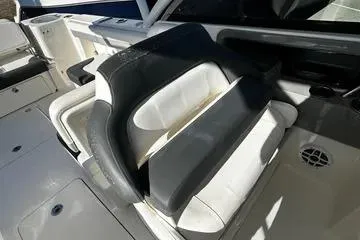 Slide: The Image of 2022 Robalo R317 Dual Console boat interior seating with white and black upholstery. - 14