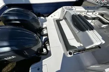 Slide: The Image of 2022 Robalo R317 Dual Console boat with Yamaha engines, featuring spacious seating. - 2