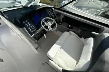 Slide: The Image of 2022 Robalo R317 Dual Console boat interior with modern dashboard and steering wheel. - 6