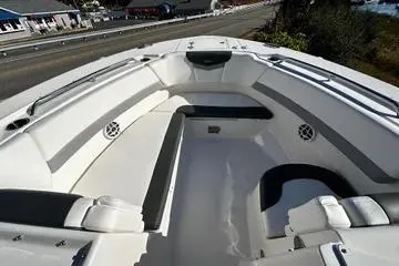 Slide: The Image of 2022 Robalo R317 Dual Console boat interior with white seating and speakers. - 8