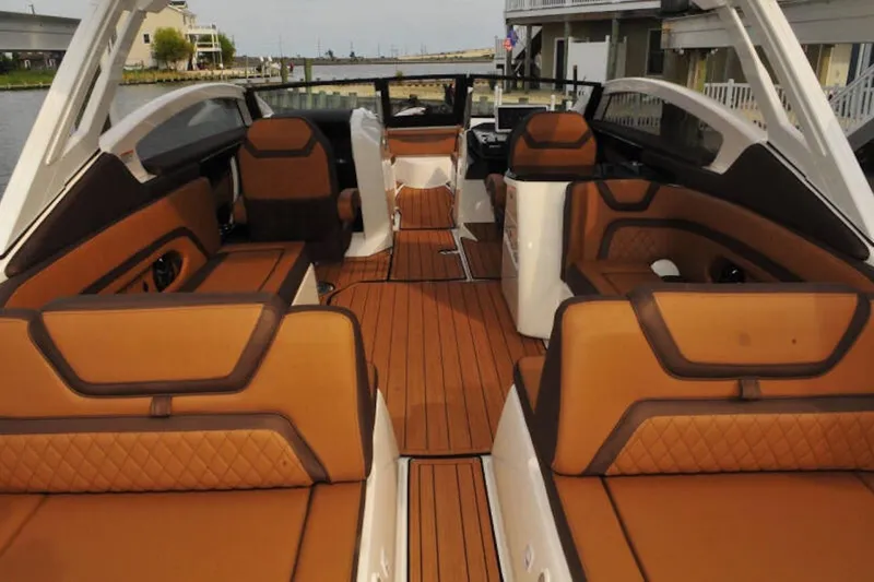 Slide: The Image of 2024 Yamaha Boats 275SDX interior with luxurious brown seating and sleek design. - 10