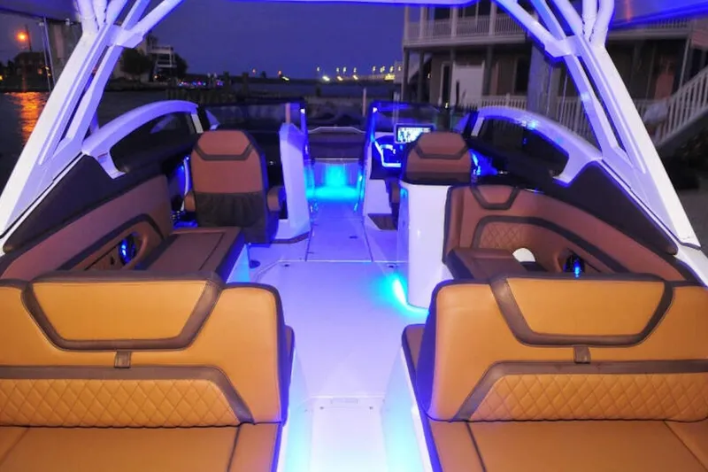 Slide: The Image of Luxurious interior of 2024 Yamaha Boats 275SDX with ambient blue lighting at night. - 11