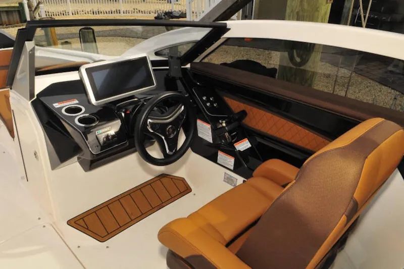 Slide: The Image of 2024 Yamaha Boats 275SDX cockpit with modern steering, touchscreen, and luxurious seating. - 16