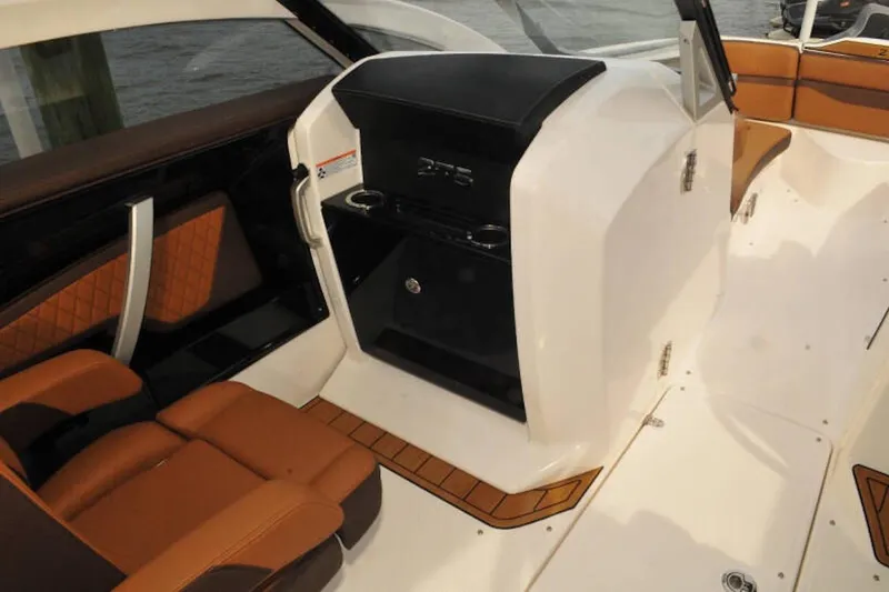 Slide: The Image of 2024 Yamaha Boats 275SDX interior with tan seating and sleek console design. - 18