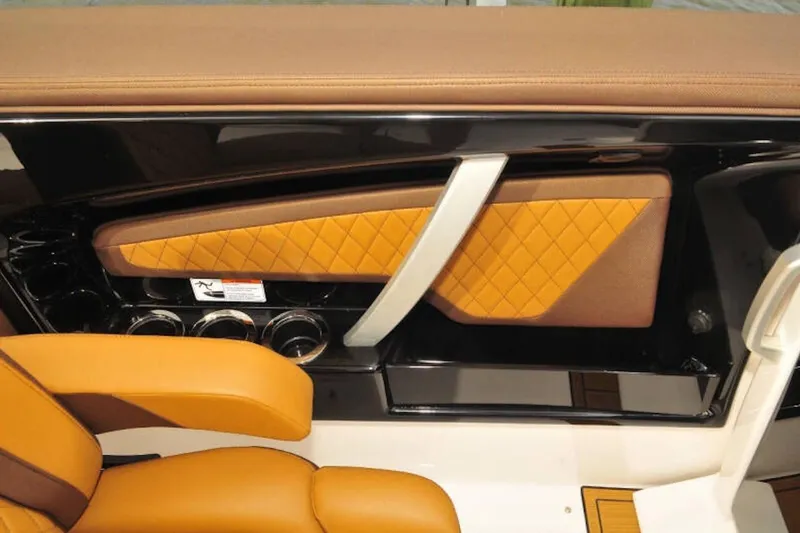 Slide: The Image of 2024 Yamaha Boats 275SDX interior with tan leather seats and stylish paneling. - 19